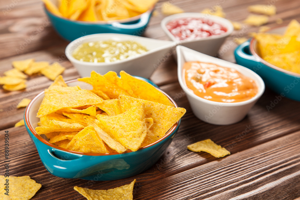 Plate of nachos with different dips