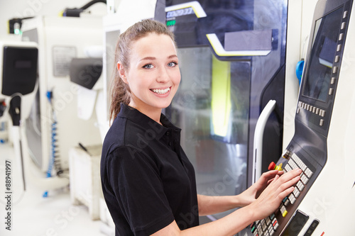 Portrait Of Female Engineer Operating CNC Machinery photo