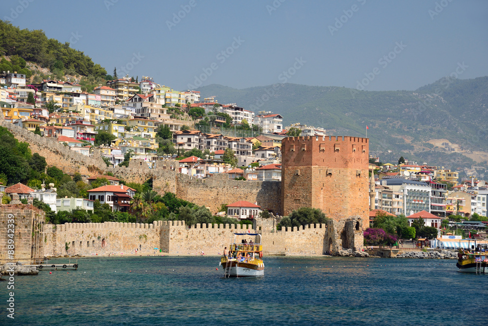 Fototapeta premium Wall of fortress and Red Tower (Kizilkule) in Alanya, Turkey 