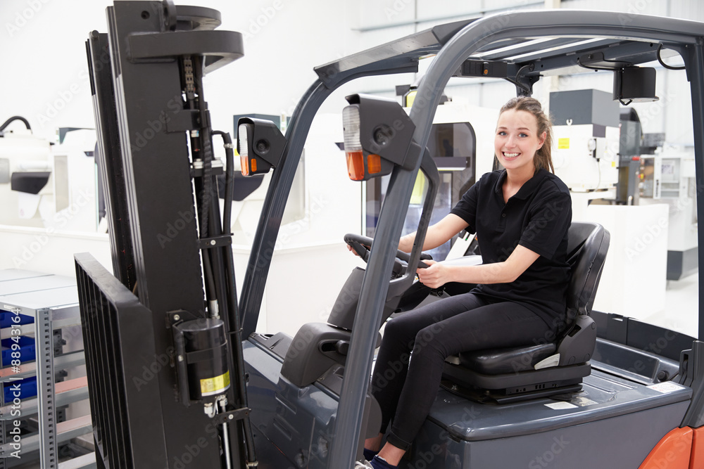 Portrait Of Female Fork Lift Truck Driver In Factory Portrait Of Female Fork Lift Truck Driver In Factory