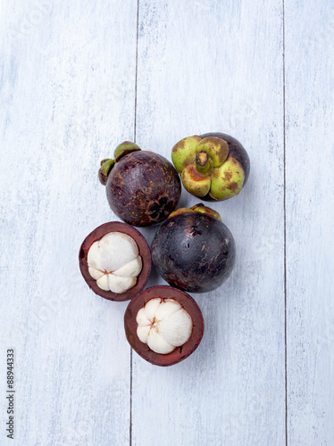 Mangosteen on white wood background vertical style