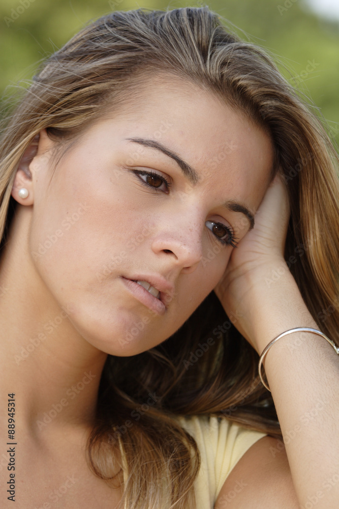 A young woman with hand on head. A young woman with hand on head.