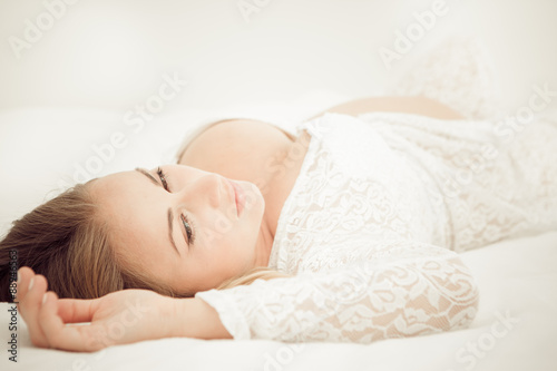 Pregnant woman lying on the bed