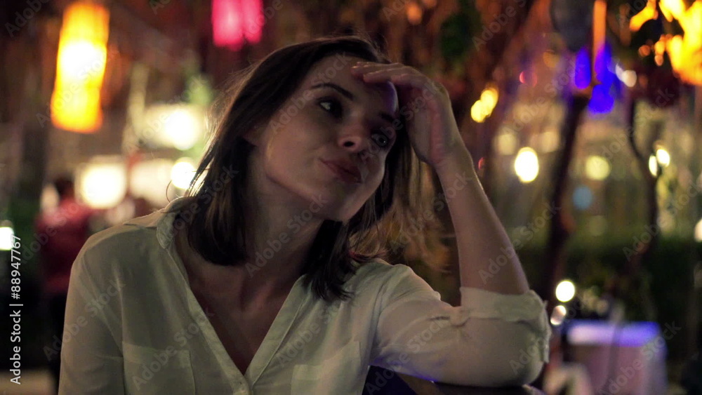 Sad, unhappy woman sitting in trendy cafe at night
Sad, unhappy woman sitting in trendy cafe at night