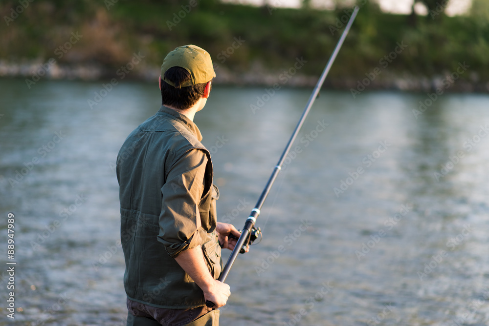 Young fisherman at the river
