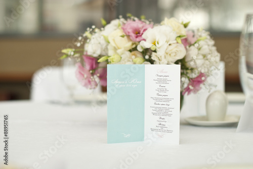 Menu card with beautiful flowers on table in wedding day 