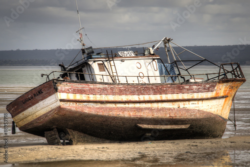 Old boat on the beach in low tide in Inhambane, Mozambique 