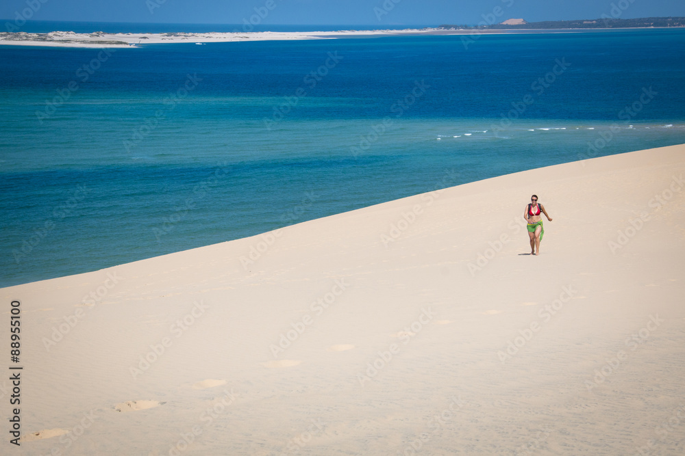 Girl walking on the white dunes on the beach of the Bazaruto Islands near Vilanculos in Mozambique with the Indian ocean in the background
Girl walking on the white dunes on the beach of the Bazaruto Islands near Vilanculos in Mozambique with the Indian ocean in the background