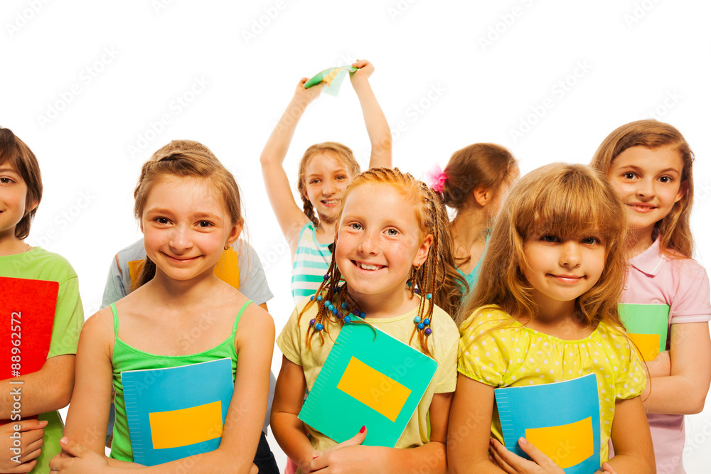 Smiling girls and boys holding textbooks Smiling girls and boys holding textbooks
