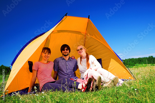 people relaxing in the tent