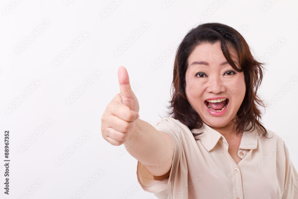 exited, happy, smiling, successful middle aged woman showing thu exited, happy, smiling, successful middle aged woman showing thu