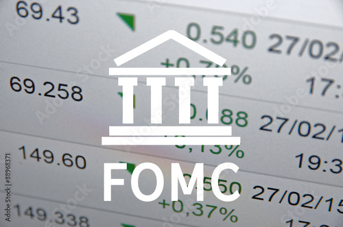 Building icon with inscription FOMC. Financial data on computer screen. Multiple exposure.