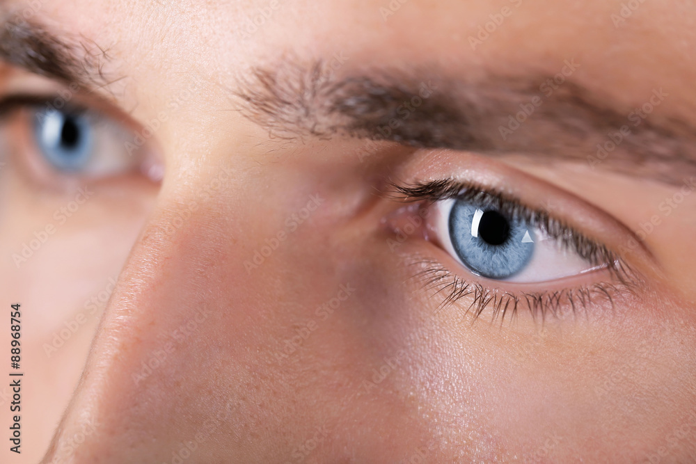 Fototapeta premium Beautiful blue man eyes close up