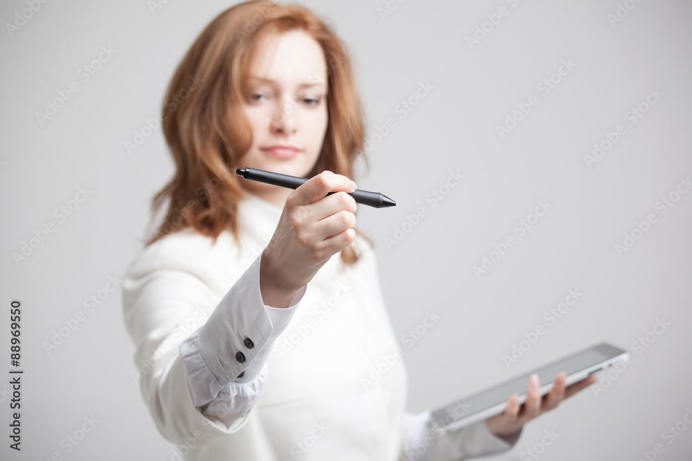 young woman with pen on grey background young woman with pen on grey background