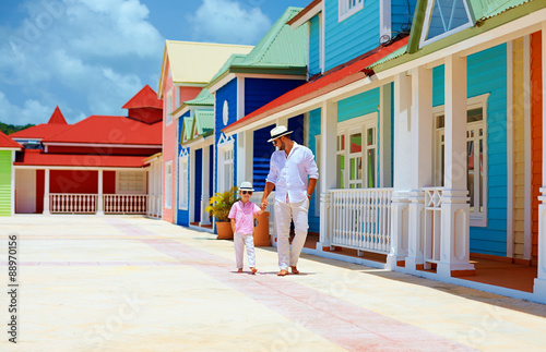 Fotografie happy father and son walking on caribbean village street