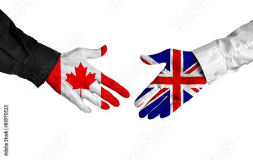 Canadian and British leaders shaking hands on a deal agreement photo