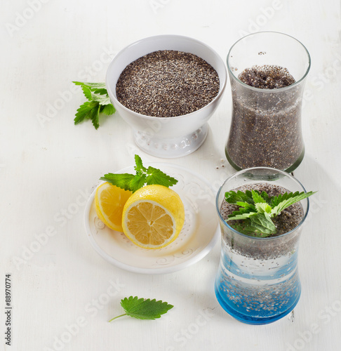 Chia seeds drink with a water, mint and lemon in glass.