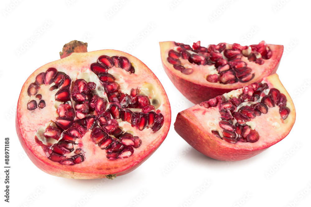 Close-up of a sliced ripe red pomegranate, isolated on white background. Close-up of a sliced ripe red pomegranate, isolated on white background.