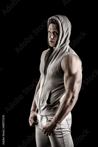 Full length shot of tough young man in dark t-shirt isolated