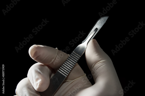 Surgery knife in doctor hand.