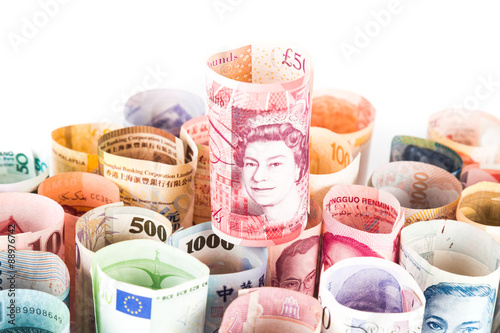 Pile of rolled-up currency notes with Sterling Pound on top