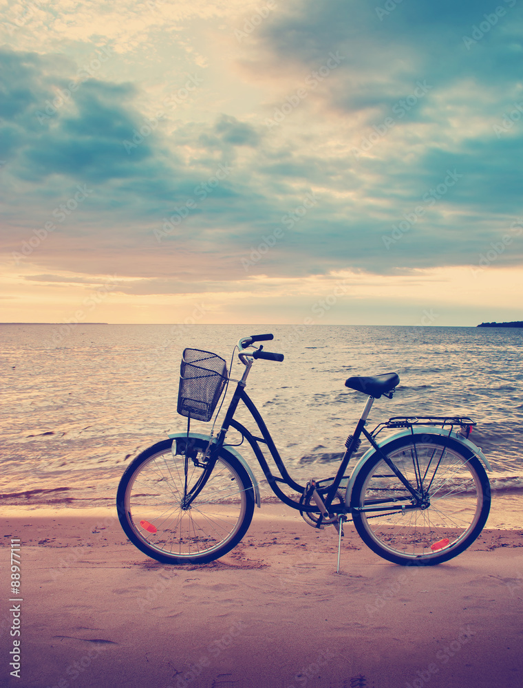 Lonely bike standing at sunset