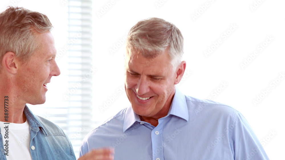 Casual businessmen using tablet computer Casual businessmen using tablet computer