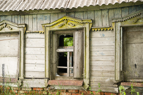 The windows in the wall of the old wooden house