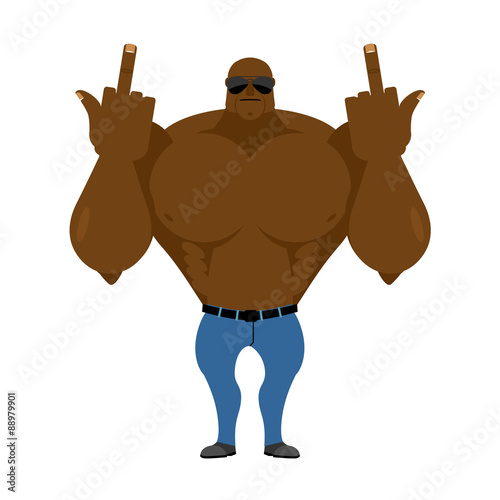 Big strong man. Bodybuilder in jeans shows fuck. Hooligan in sun