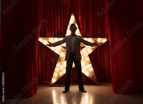 Man on stage with star on background