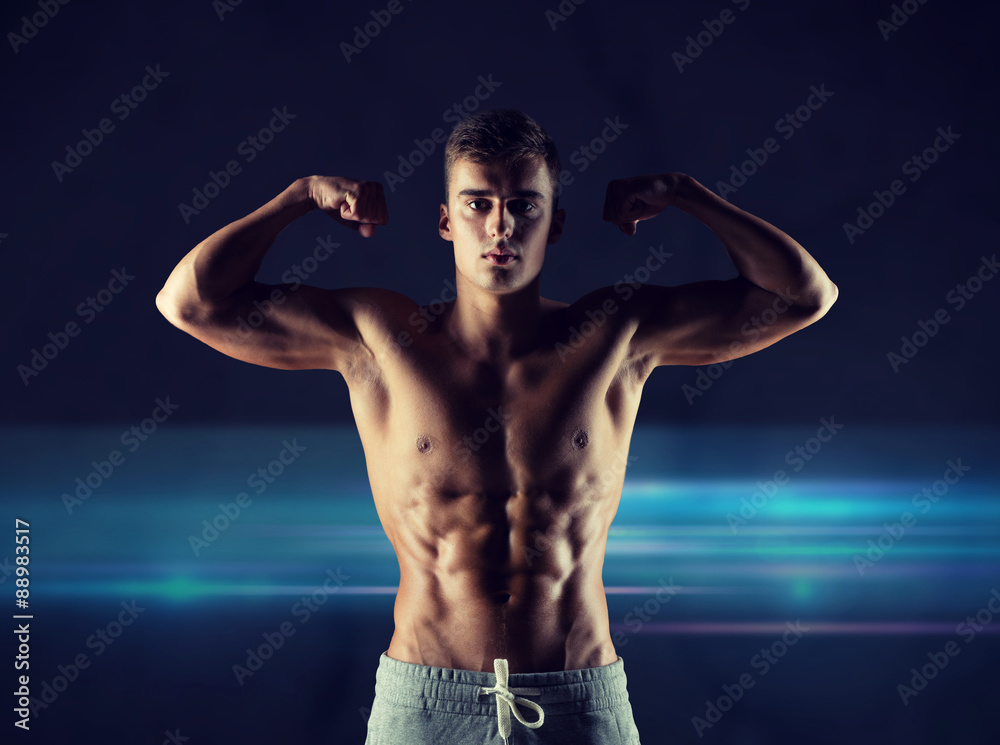 young man showing biceps and muscles