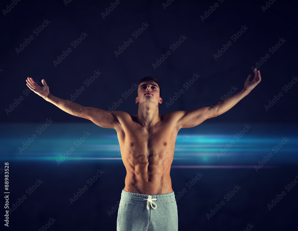 Obraz premium young male bodybuilder with raised hands