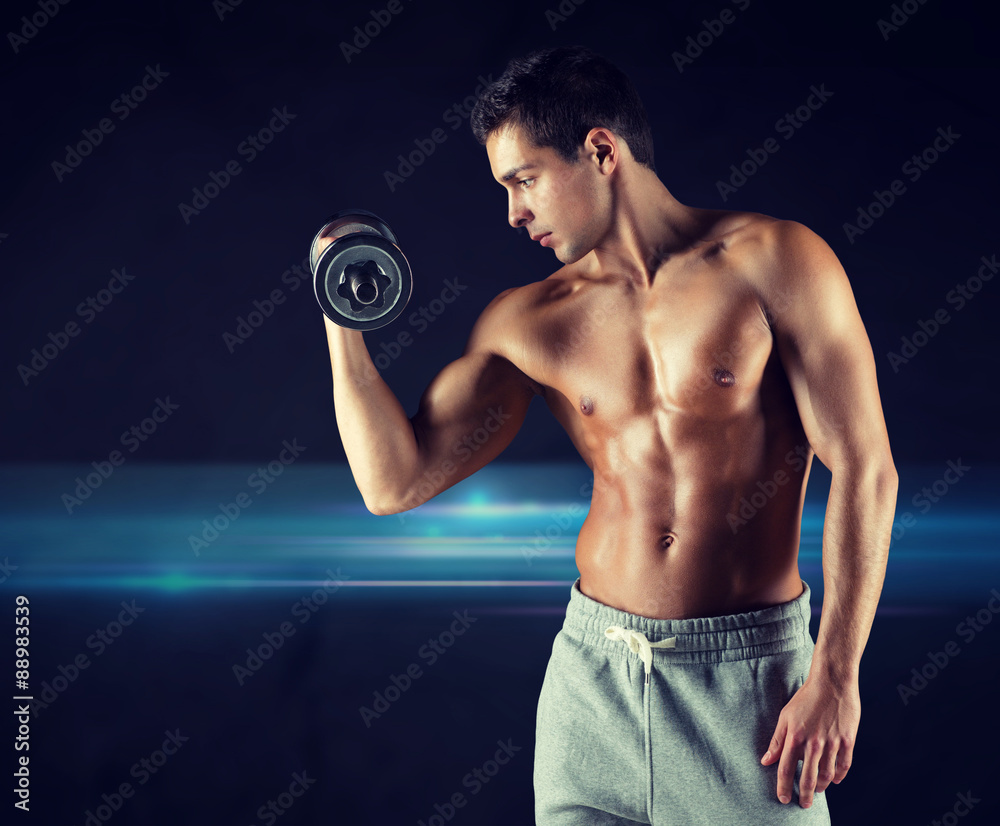 young man with dumbbell flexing biceps young man with dumbbell flexing biceps