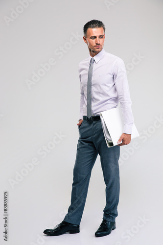 Handsome businessman standing with folder