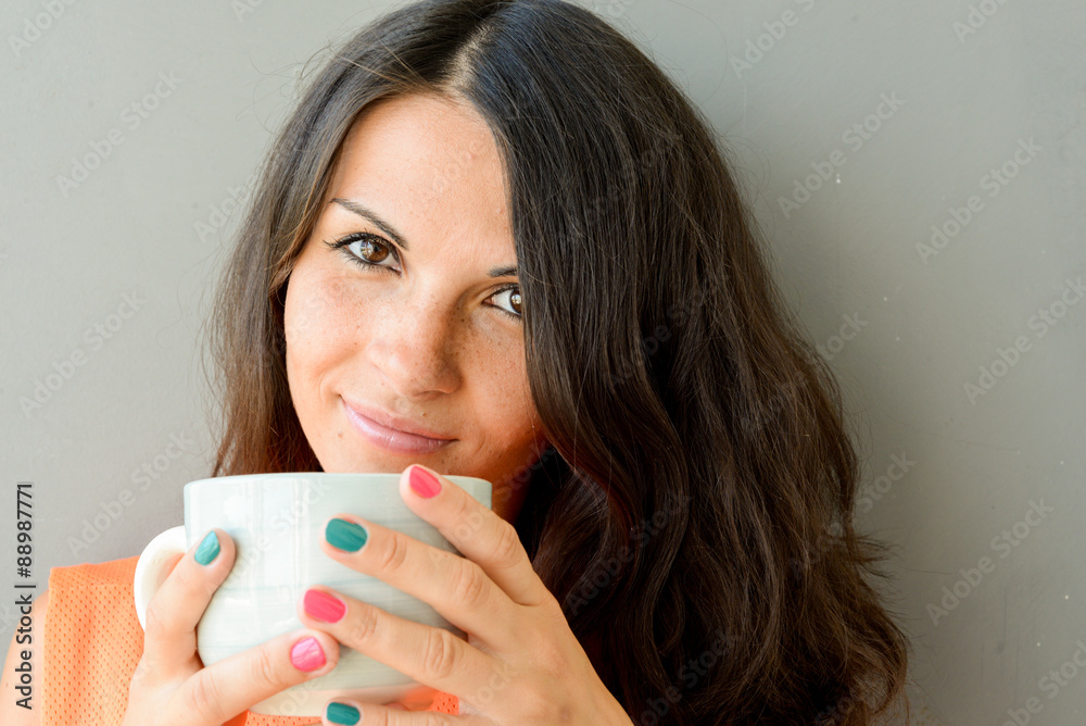 Beautiful Pretty Happy Young Woman drinking coffee and smiling. Standing with coffee mug .Having Fun. Concept of freedom and happiness Beautiful Pretty Happy Young Woman drinking coffee and smiling. Standing with coffee mug .Having Fun. Concept of freedom and happiness