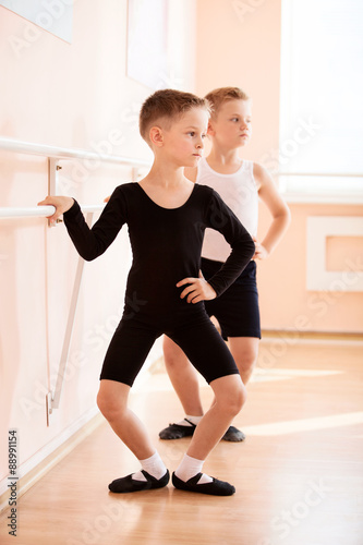 Obraz na plátně Young boys working at the barre in a ballet dance class.