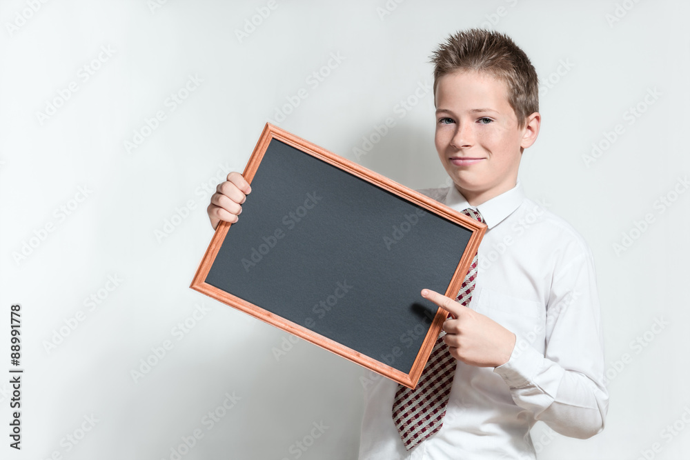 Smiling schoolboy with clean black chalkboard Smiling schoolboy with clean black chalkboard
