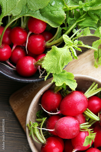 Fresh red radish on wooden table, closeup