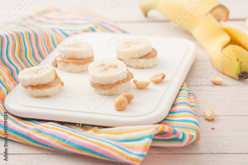 banana slices with peanut butter on white board photo