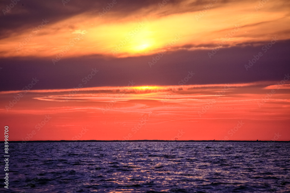 Amazing Sunset over an ocean with clouds