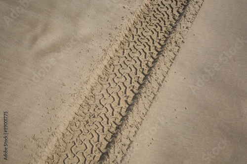 The trace of a tyre in the sand on the beach...