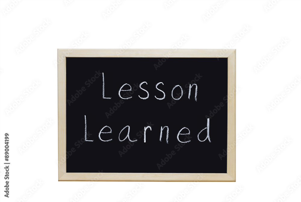 Lesson Learned written with white chalk on blackboard. Lesson Learned written with white chalk on blackboard.
