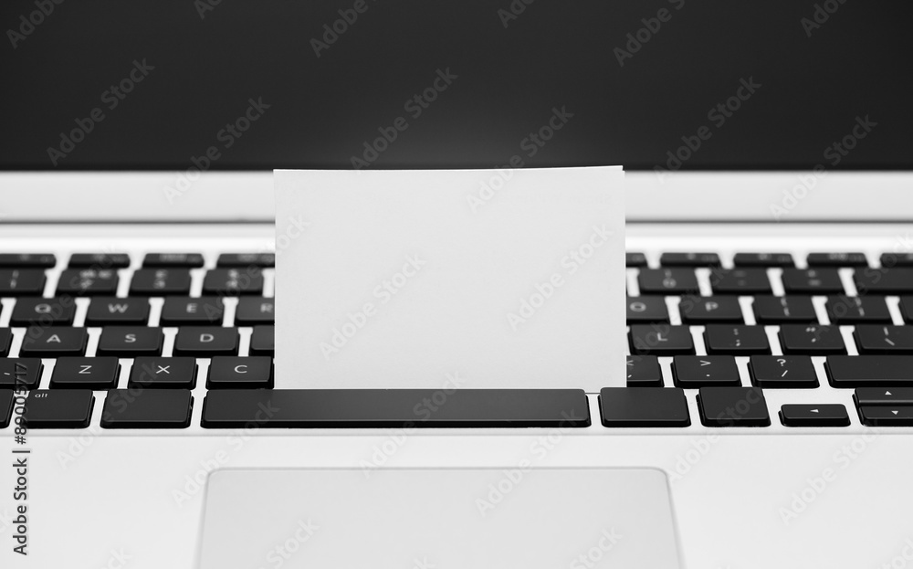 Blank Business card on computer keyboard Blank Business card on computer keyboard
