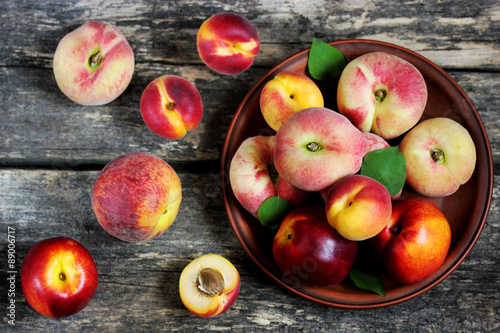 Assortment of peaches, apricots, nectarines on a wooden background