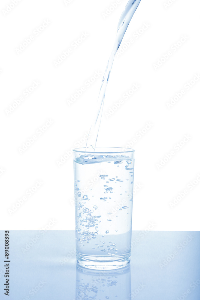 Pouring water from bottle into glass on white background. Pouring water from bottle into glass on white background.
