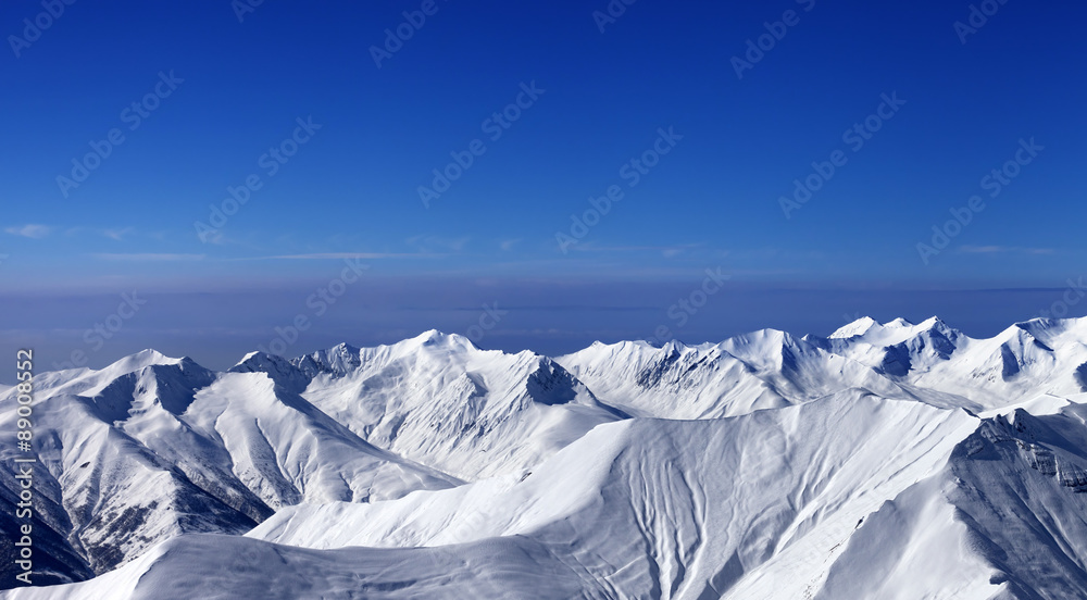 Panoramic view on off-piste slopes and multicolor blue sky at ni