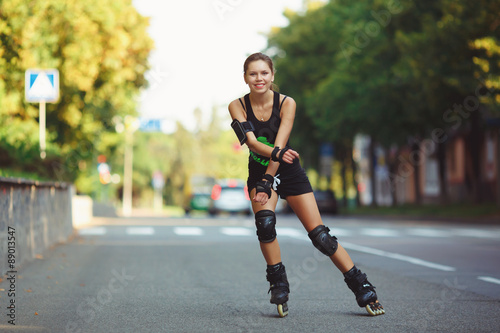 Cheerful girl on roller skates photo