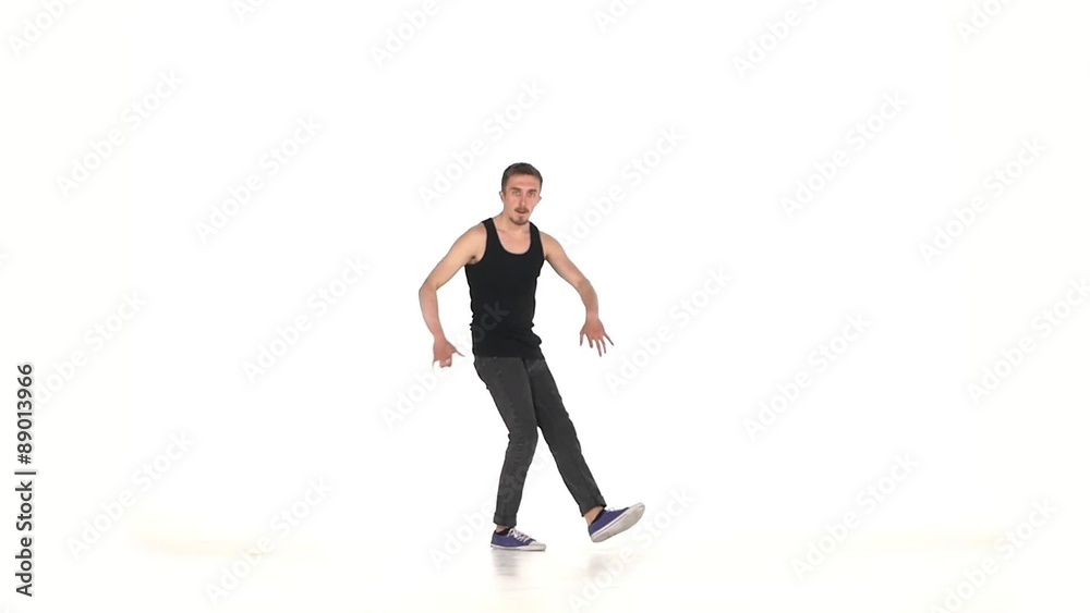 Young b-boy man doing brake dancing movements, on white, slow