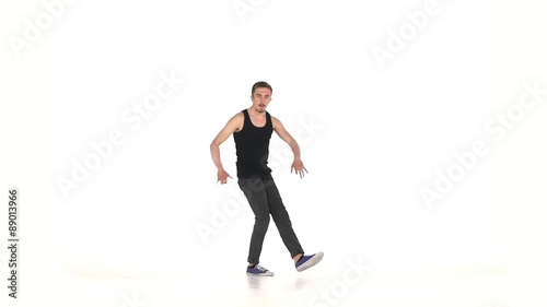 Young b-boy man doing brake dancing movements, on white, slow photo