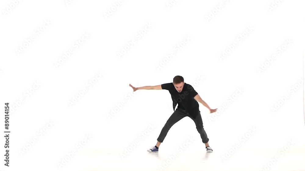 Modern dancer dancing brake-dance on hands, white, slow motion Modern dancer dancing brake-dance on hands, white, slow motion